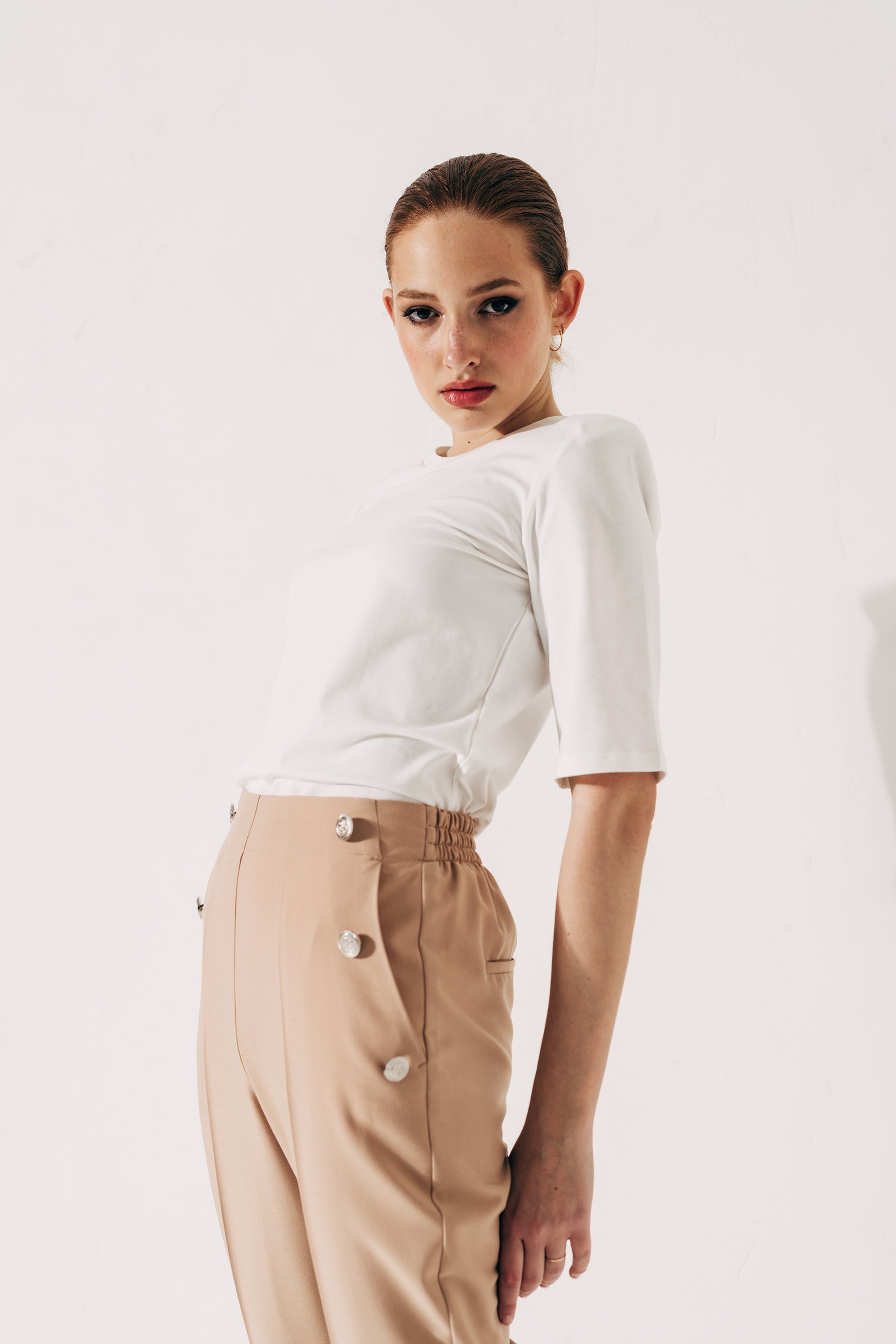 Straight trousers with decorative metal buttons